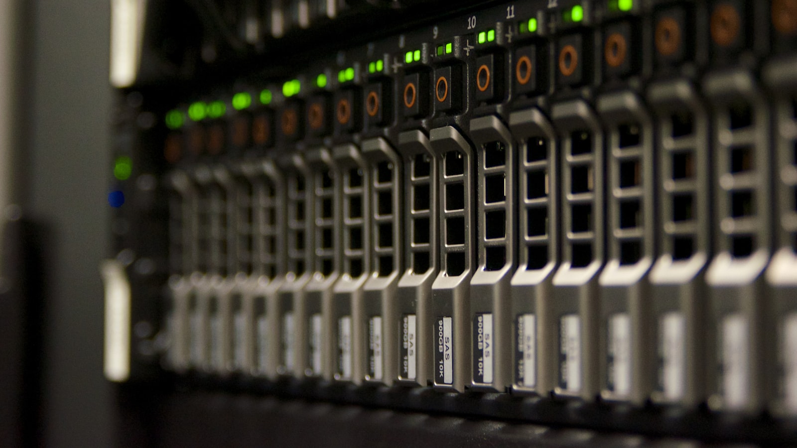 A close-up row of server drive bays with green status lights