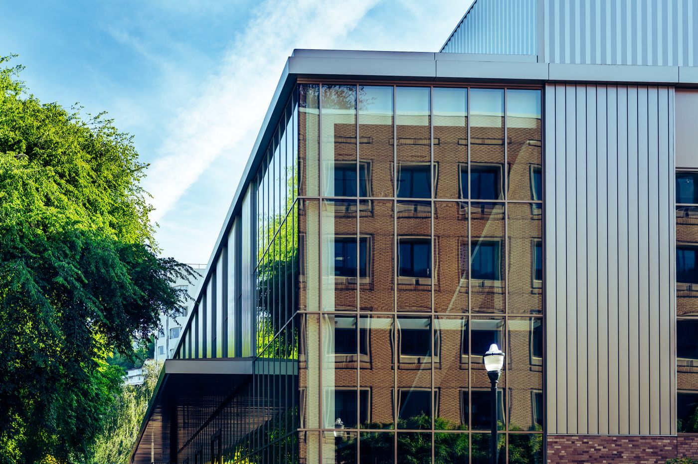 A reflective glass facade mirroring the buildings opposite.