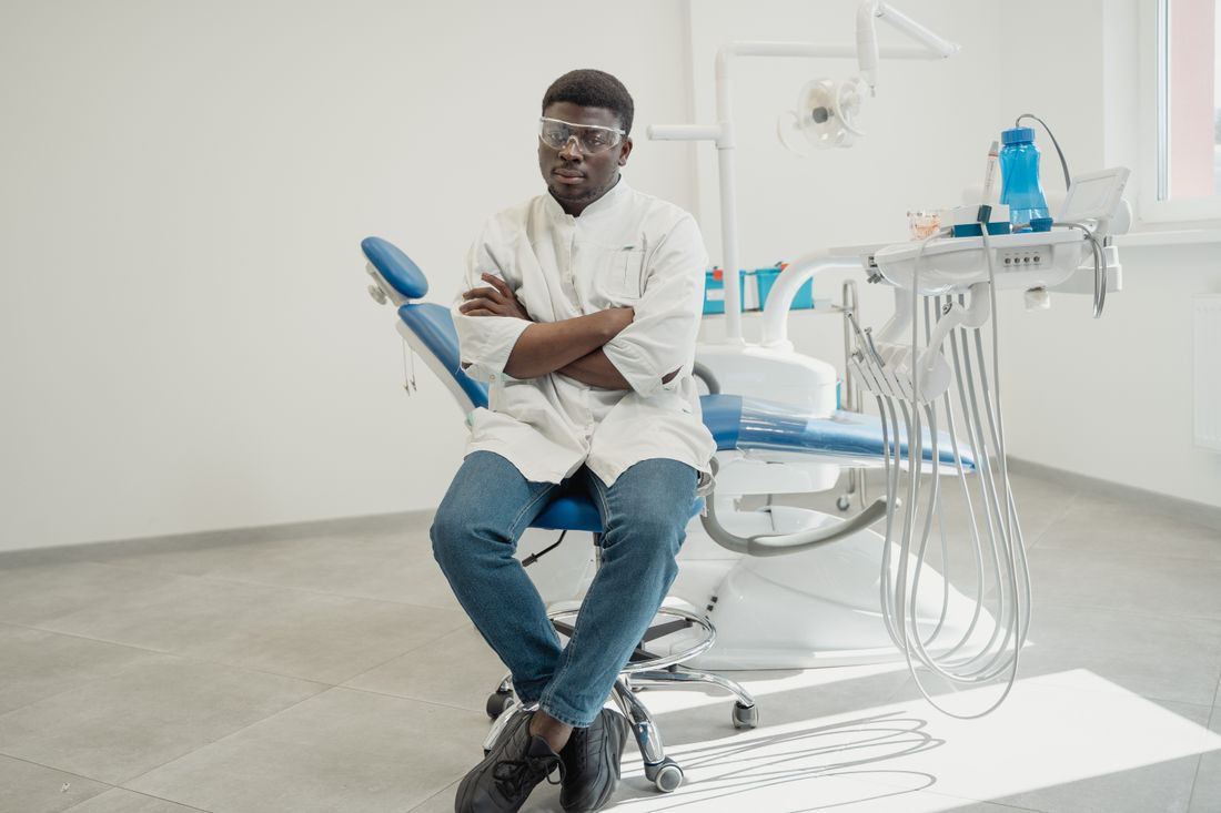 Dr Marcus Feltrin, seated beside the chair in his treatment room.