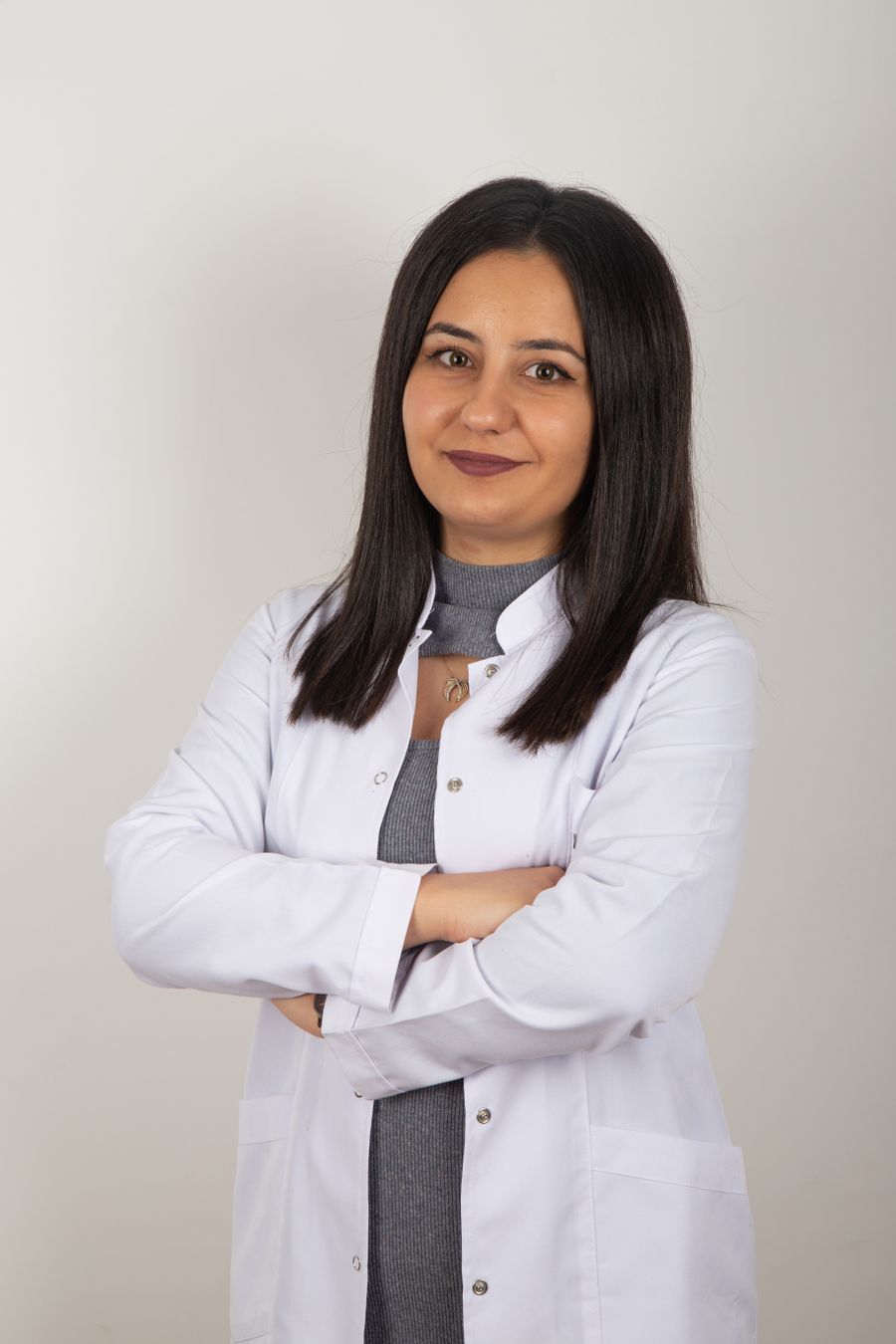 Portrait of Dr Ines Karabo in a white coat.