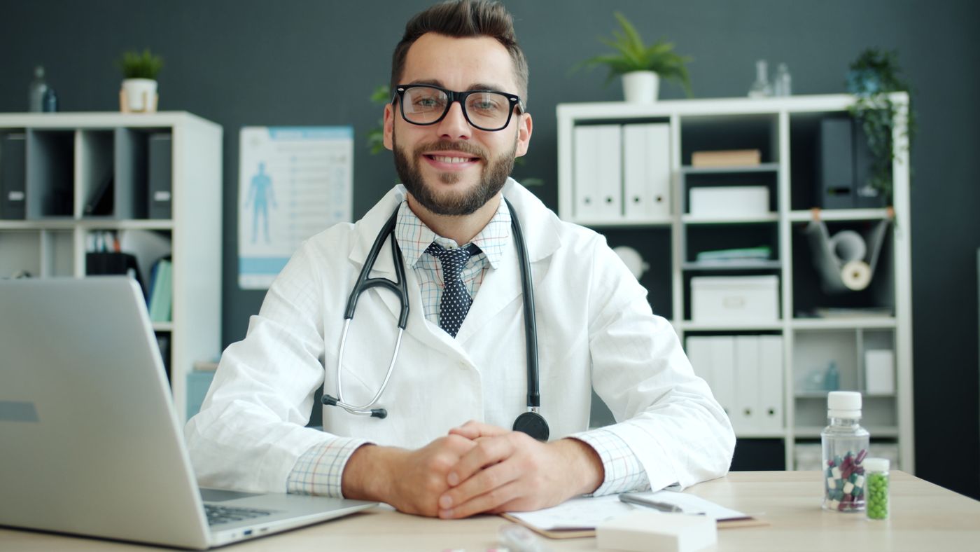 A doctor at a desk in a consulting room at Marlow.