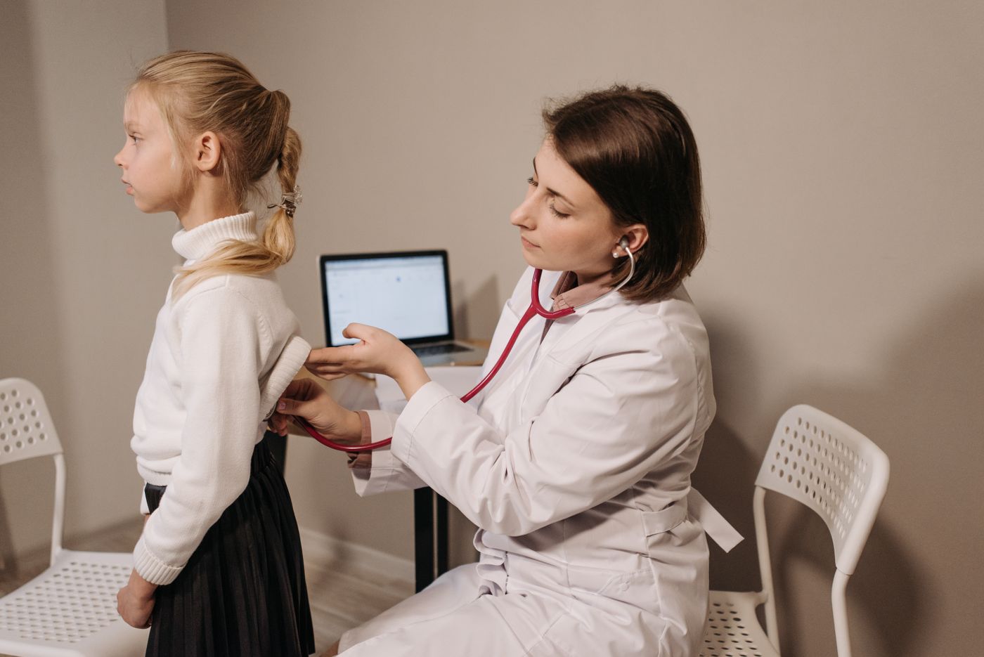 A consulting room at Hazelbrook with a child being examined.
