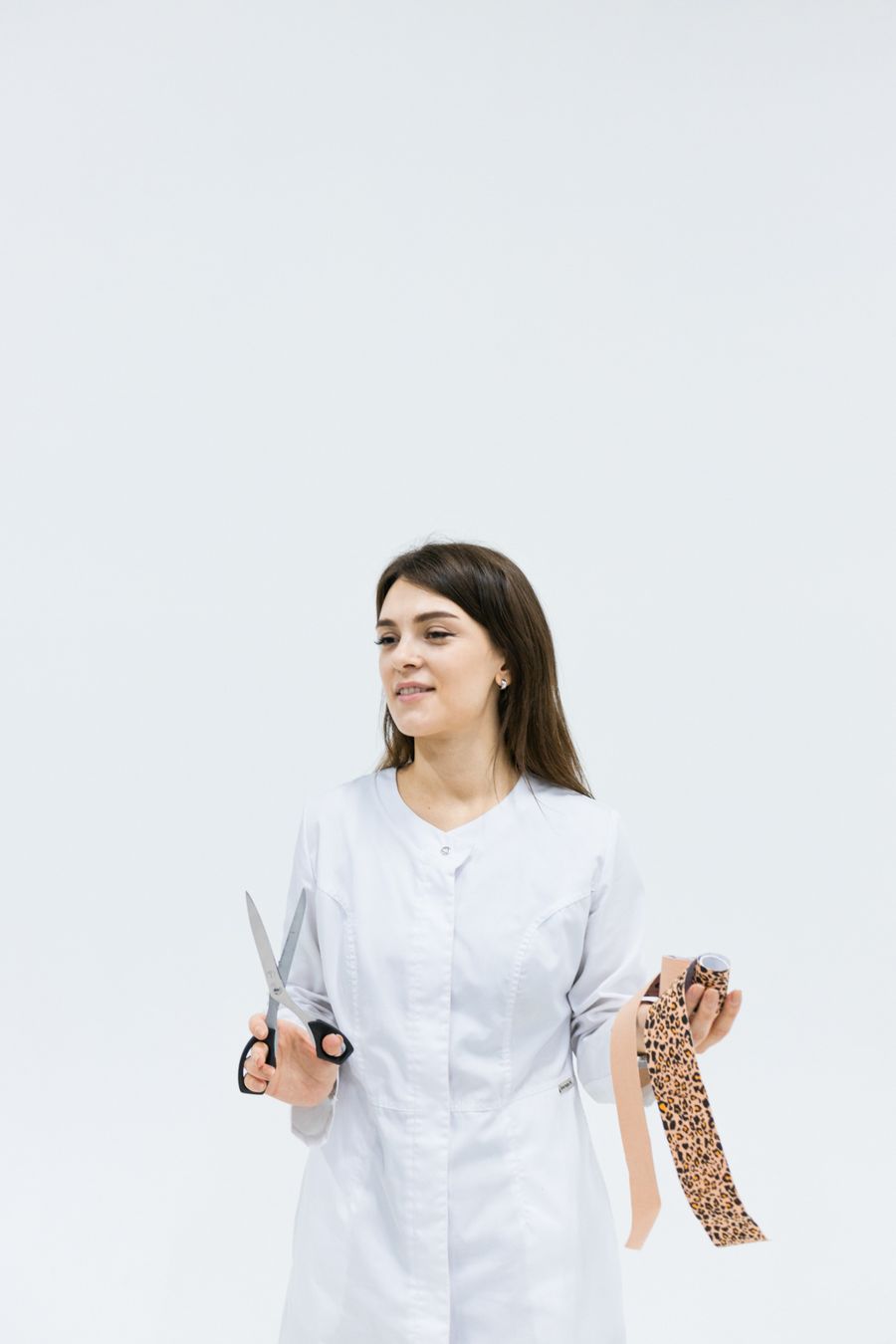 Portrait of Nadia Brannigan holding kinesiology tape.